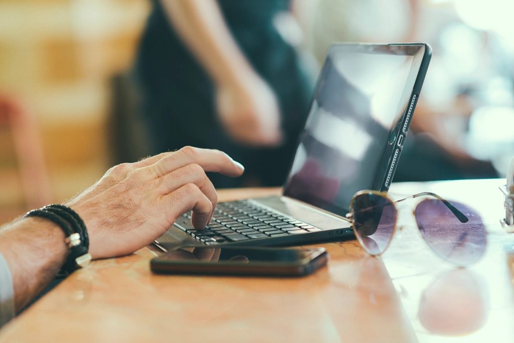 One hand resting on a keyboard